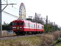 観覧車をバックに快走する7711F
