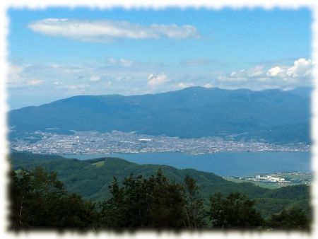 守屋山から諏訪湖を隔てて鉢伏山（正面右）、高ボッチ（正面左）を望む。画面右端には美ヶ原がほんの少し。