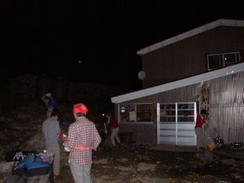 in front of the hut, still nightime