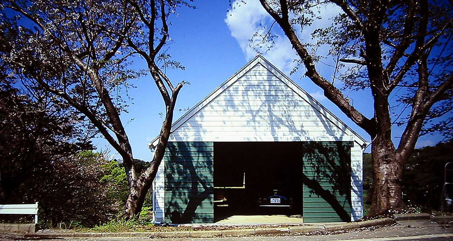 大磯　傾斜地の家　切妻屋根の白い下見板張りの外観写真